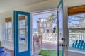 Step through your private doors onto a peaceful deck where coastal breezes and ocean views await. Settle into the wooden bench and unwind while glimpsing the sea beyond the trees.