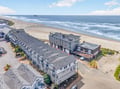Beachfront property complex offering direct access to pristine sandy shores and rolling Pacific waves.