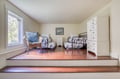 Enjoy your own peaceful retreat in this bright bedroom featuring two cozy twin beds with charming vintage frames, a relaxing reading nook by the window, and plenty of storage space for all your belongings.