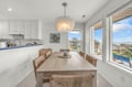 Gather with loved ones around this elegant dining table under a beautiful chandelier, while ocean breezes and stunning coastal views fill your space with light and tranquility.