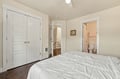 Relax in your peaceful bedroom with plush bedding, elegant hardwood floors, and an ensuite bathroom just steps away for ultimate convenience.