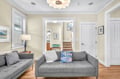 Sink into your stylish gray sectional where coastal charm meets modern comfort in this bright, welcoming living space.