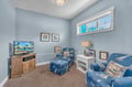 Sink into nautical-themed seating while enjoying your favorite shows in this cozy room designed for relaxation.