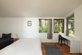 Wake up to forest views streaming through your bedroom windows, where modern comfort meets nature's tranquility in this serene retreat.
