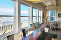 Watch ocean waves roll in through expansive windows while you relax with morning coffee or your favorite book in this light-filled room. The cozy window seat and breezy coastal style make every moment feel like a peaceful retreat.