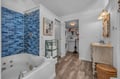 Relax in your spa-inspired bathroom with ocean-blue tiling and a jetted tub that melts stress away.