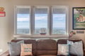 Sink into this cozy sofa and let your eyes wander to the expansive forest views beyond the windows—your peaceful retreat awaits.
