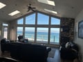 Wake up to breathtaking ocean views from your spacious living room, where floor-to-ceiling windows frame the endless blue horizon and waves rolling to shore.