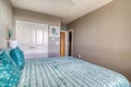 Sink into coastal comfort with this serene bedroom's turquoise accents and plush bedding, your peaceful retreat after seaside adventures.