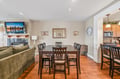 Gather around the dining table for meals with family and friends, with comfortable seating for six and a cozy living area nearby for relaxing after dinner.