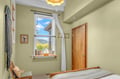 Drift off to sleep in this serene bedroom while taking in stunning mountain vistas through your window. The soft sage walls and high ceilings create a peaceful retreat for your getaway.