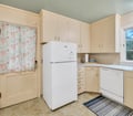 Your fully equipped kitchen offers vintage charm with ample cabinet space, dishwasher, full-size refrigerator, and a bright corner layout for easy meal prep during your stay.