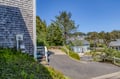 Coastal neighborhood with shingled homes nestled among evergreens, offering a peaceful retreat near the water.