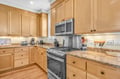 Your fully equipped kitchen awaits with granite counters, maple cabinets, and modern appliances ready for memorable meals.
