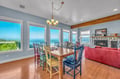 Gather around this charming dining table while soaking in breathtaking ocean views through expansive windows.