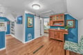 Step into your charming coastal retreat where ocean-blue walls meet warm wood floors, creating the perfect seaside sanctuary for relaxation.
