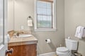 Your private bathroom features a warm wood vanity and peaceful window view for refreshing mornings.