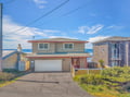 Charming beachside home with stunning ocean views and convenient garage parking in a peaceful coastal neighborhood.