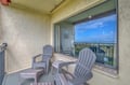 Unwind on your private balcony with comfortable seating and sweeping views of the coastline stretching to the horizon.