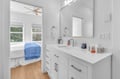 Step into your pristine en-suite bathroom with gleaming white countertops, modern fixtures, and thoughtful touches that make your morning routine effortless.