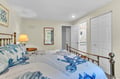 Drift off in your coastal-themed bedroom with charming nautical bedding, warm lamplight, and your private ensuite bathroom just steps away.
