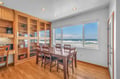 Your oceanfront dining space features stunning sea views through panoramic windows, perfect for memorable meals with the sound of waves.