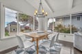 Gather around your bright dining space with vaulted ceilings and wrap-around windows showcasing peaceful neighborhood views.