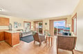 Step into your bright, open living space where coastal breezes and ocean views await through the sliding doors. Relax in wicker seating or unwind on the plush sofa—your perfect island escape starts here.