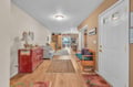 Your cozy entryway welcomes you with warm wood floors, charming vintage touches, and an inviting bench to settle in.