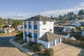 A distinctive coastal property featuring modern architecture and convenient parking, situated in a peaceful neighborhood surrounded by natural beauty and nearby residential areas.
