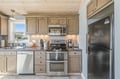 Your fully equipped kitchen features warm wood cabinetry, modern stainless appliances, and everything you need to prepare home-cooked meals during your coastal getaway.