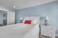 Drift off in this serene bedroom with soft blue walls, crisp white linens, and charming touches that create your perfect retreat.