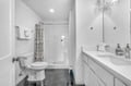 Step into your pristine bathroom with spacious shower, crisp linens, and elegant marble floors for ultimate comfort.