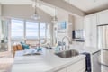Your bright, open kitchen flows into the living area where stunning ocean views fill every window.