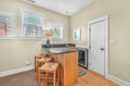 Your charming wet bar with granite counters and bar seating creates the perfect spot for morning coffee or casual meals.