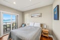 Wake up to stunning ocean views from your private balcony. This serene bedroom invites restful mornings with coastal breezes and peaceful scenery right outside your door.