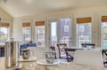 Sip your morning coffee at the dining table while gazing through large windows at the sparkling ocean beyond. Natural light fills this inviting space where relaxed coastal living begins.