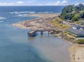 Aerial view of the coastal area surrounding the property, showcasing a scenic beach, nearby oceanfront homes, and the natural beauty of the Pacific Northwest shoreline.