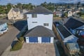 This two-story rental sits in a friendly residential neighborhood, with nearby homes, tree-lined streets, and distant mountain views framing the area. The property features private parking and easy access to surrounding local amenities.
