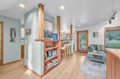 Gather around the open kitchen bar or sink into the plush armchair with your favorite book from the built-in shelves.