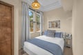 Drift off to sleep in this cozy bedroom, where natural light pours through charming windows and crisp linens invite you to unwind after a day of exploring.