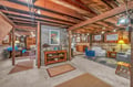 Unwind in this charming basement retreat where exposed beams and vintage touches create your perfect hideaway for relaxation.