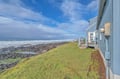 Oceanfront property offers dramatic coastline views with waves crashing against rocky shores and expansive blue skies.