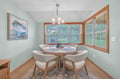 Gather around your elegant dining nook, where warm wood tones and soft lighting create perfect moments for intimate meals together.
