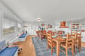 Gather around the rustic dining table for memorable meals, or relax in the cozy living area with nautical touches and warm wood accents throughout your coastal retreat.