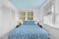 Drift off to sleep surrounded by botanical prints and natural light in your peaceful bedroom retreat with garden views.