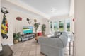 Unwind in this bright living space with comfy seating, entertainment center, and garden doors that fill your retreat with natural light.