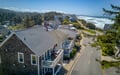 Coastal property situated on a scenic street with ocean access, surrounded by natural forest and neighboring vacation homes in a peaceful beachside community.