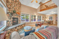 Sink into plush seating by your stone fireplace, where natural textures and warm wood create the perfect backdrop for cozy evenings together.