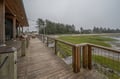 A spacious wooden deck overlooks serene coastal wetlands and evergreen forests, offering peaceful marsh views perfect for your morning coffee or evening relaxation.